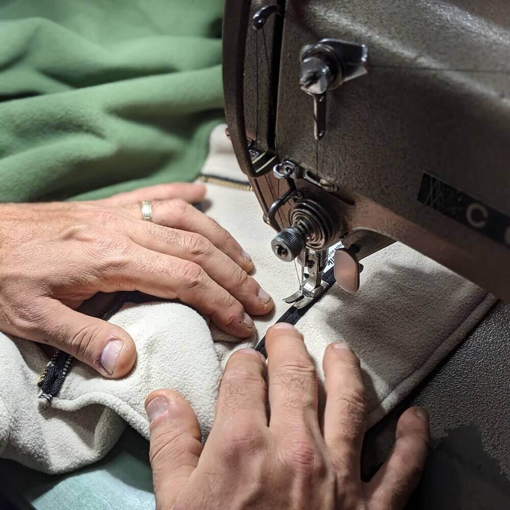 Pair of hands sewing a fleece